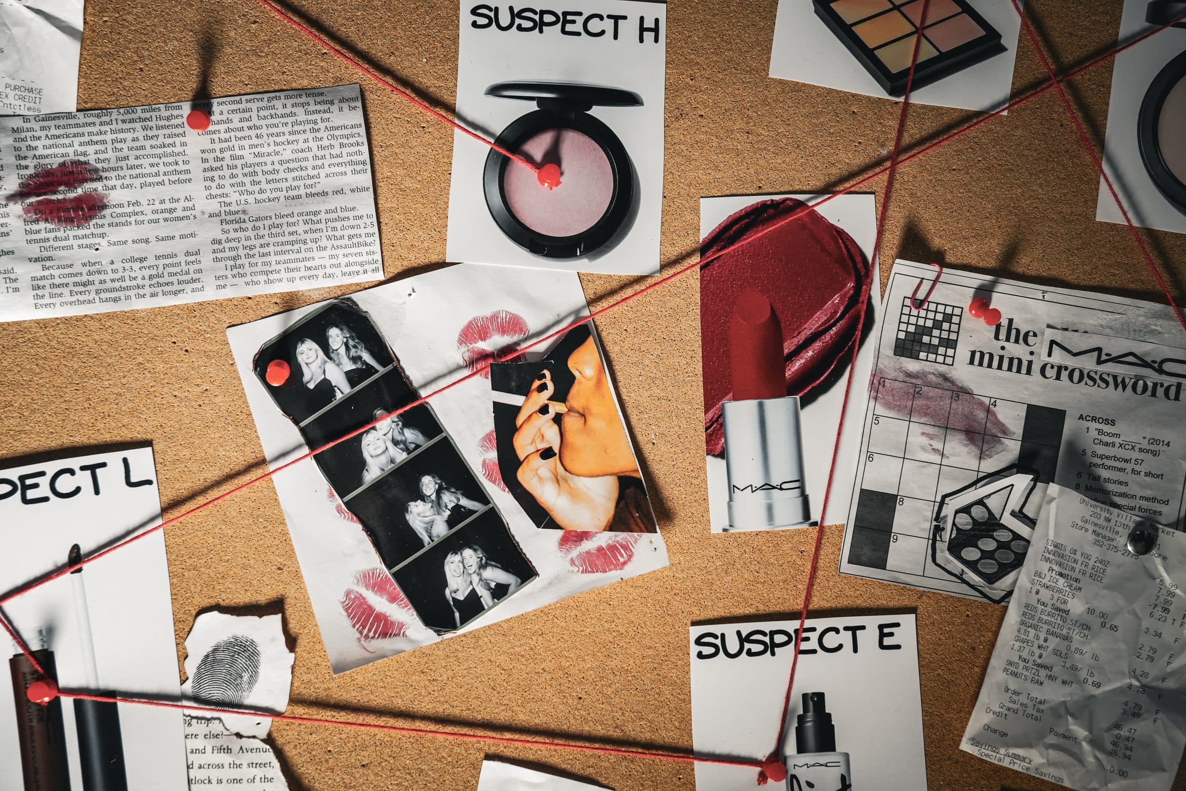 A close-up of the same board: a pink M.A.C. blush compact tagged SUSPECT H, a red lipstick bullet, a black and white photo booth strip, a mocked-up M.A.C. mini crossword and a fingerprint, all crossed by red string.